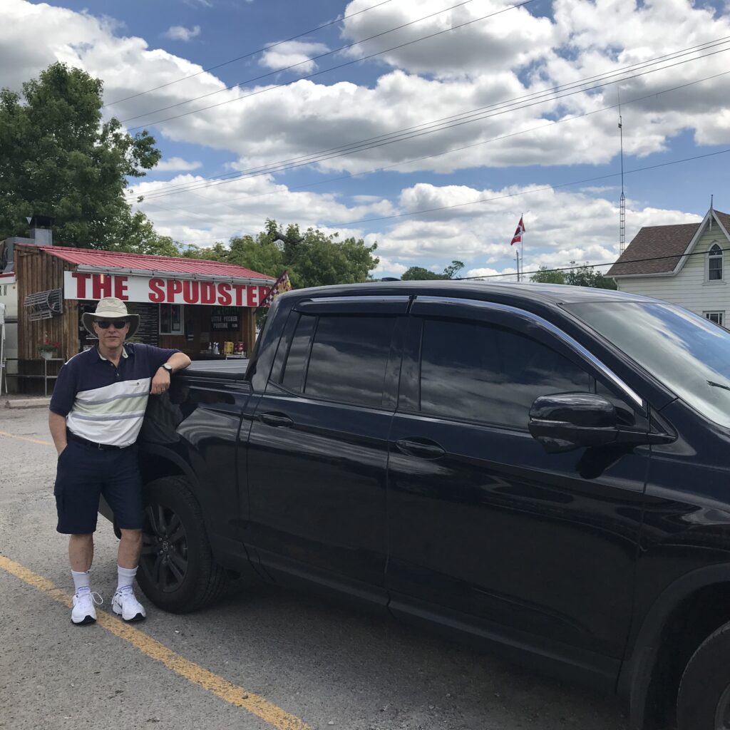 Former always in a suit corporate lawyer wearing shorts, leaning on my Pick Up Truck