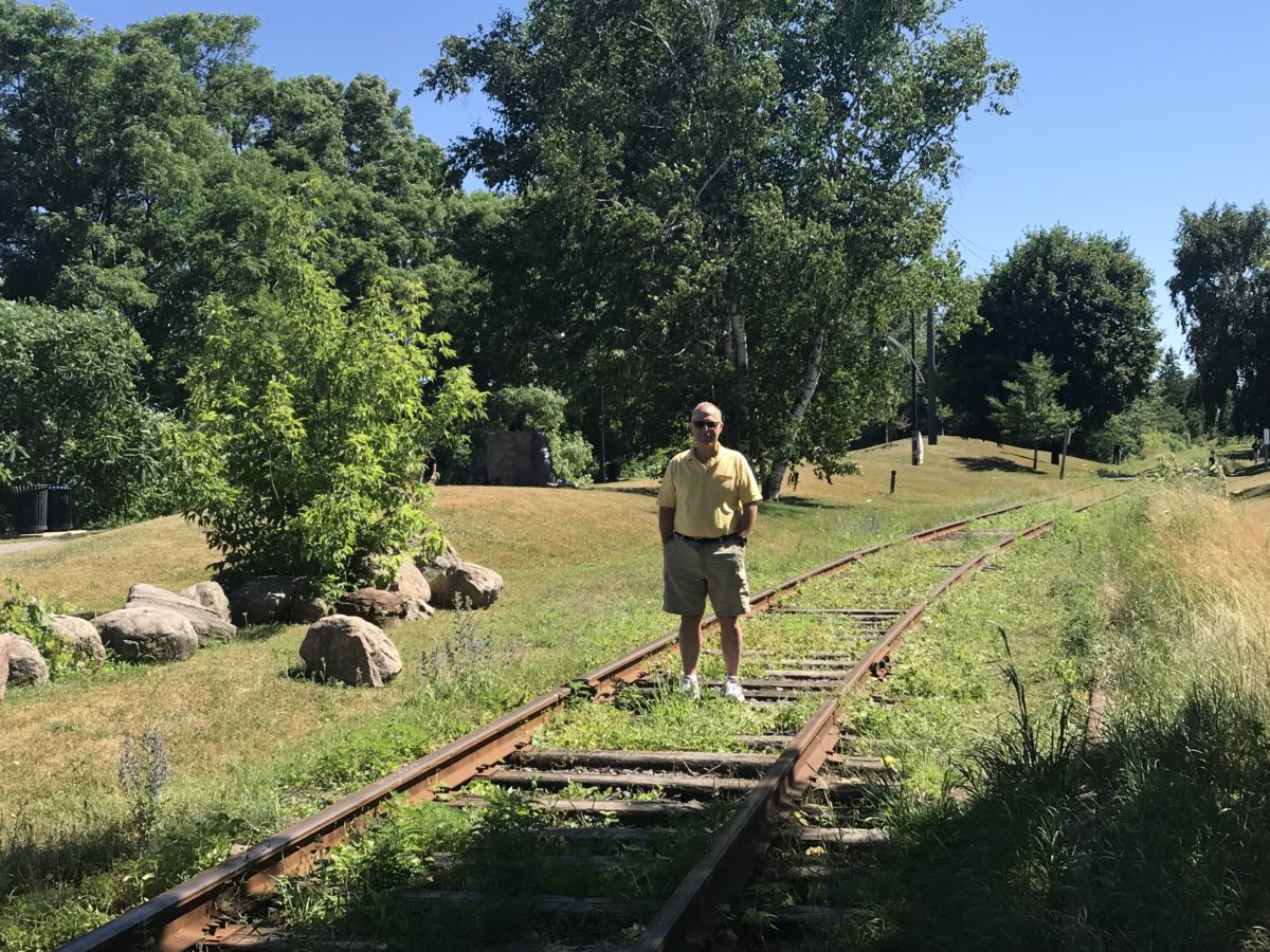 The author standing on a train track suggesting the danger of walking the ethical line.