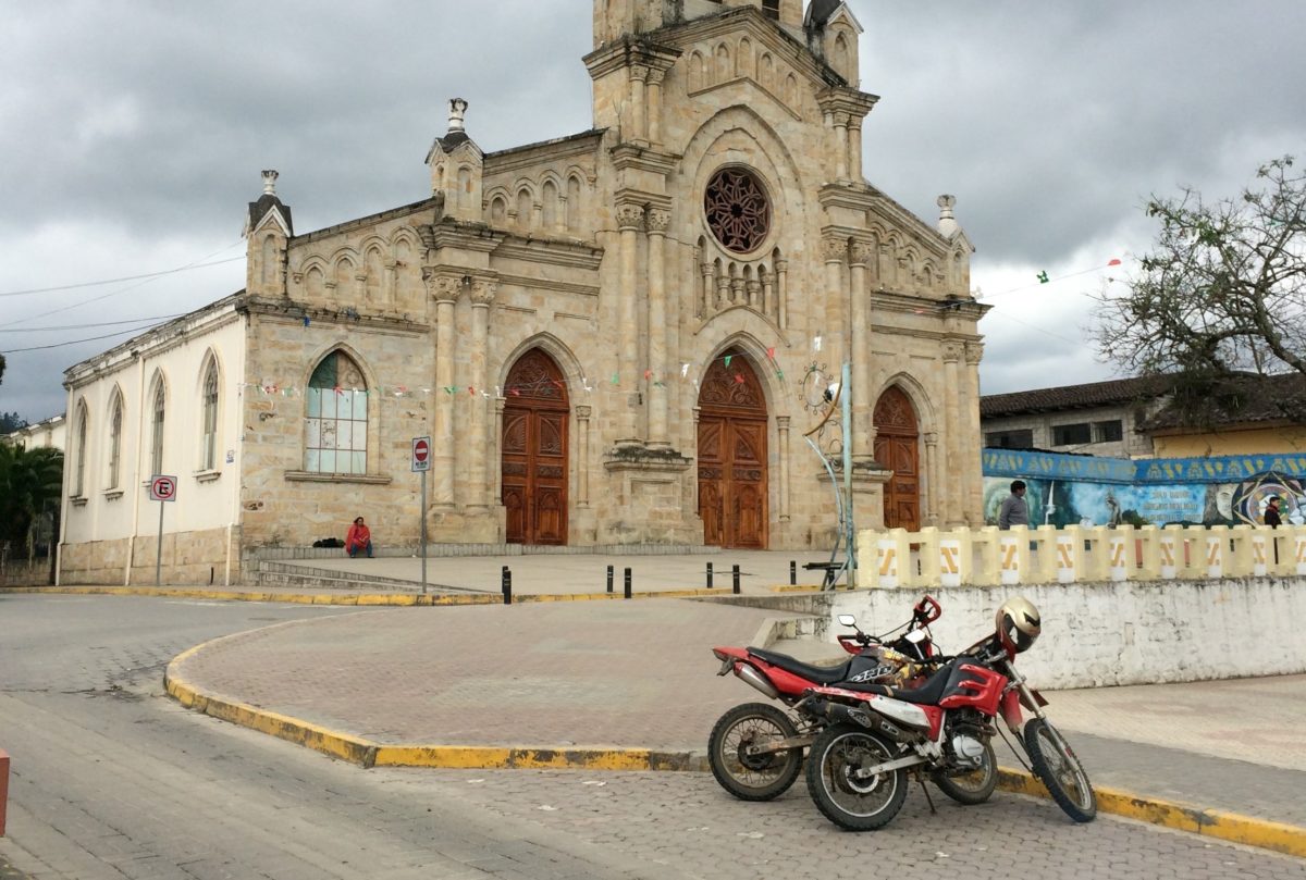 Traditional Church with modern motorcycles parked out front.