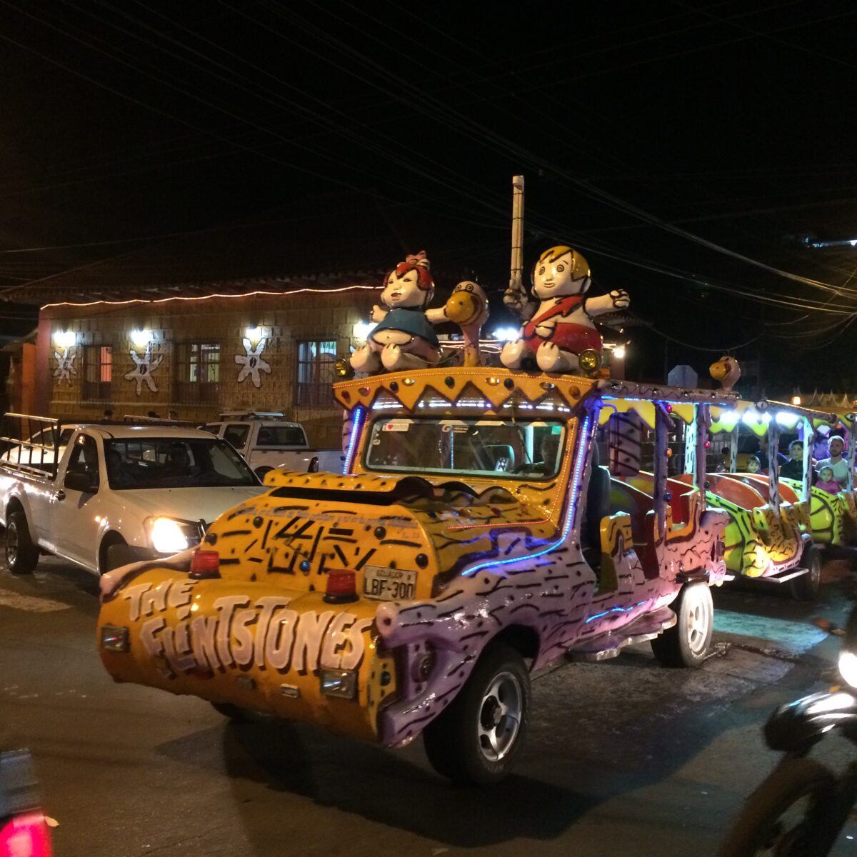 A replica of Fred Flintsone's car with cartoon characters in it.