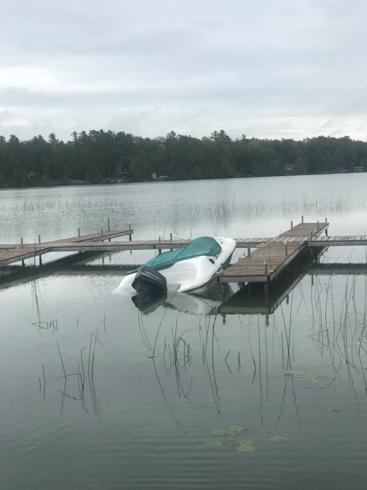 Speed boat at the dock partially submerged.