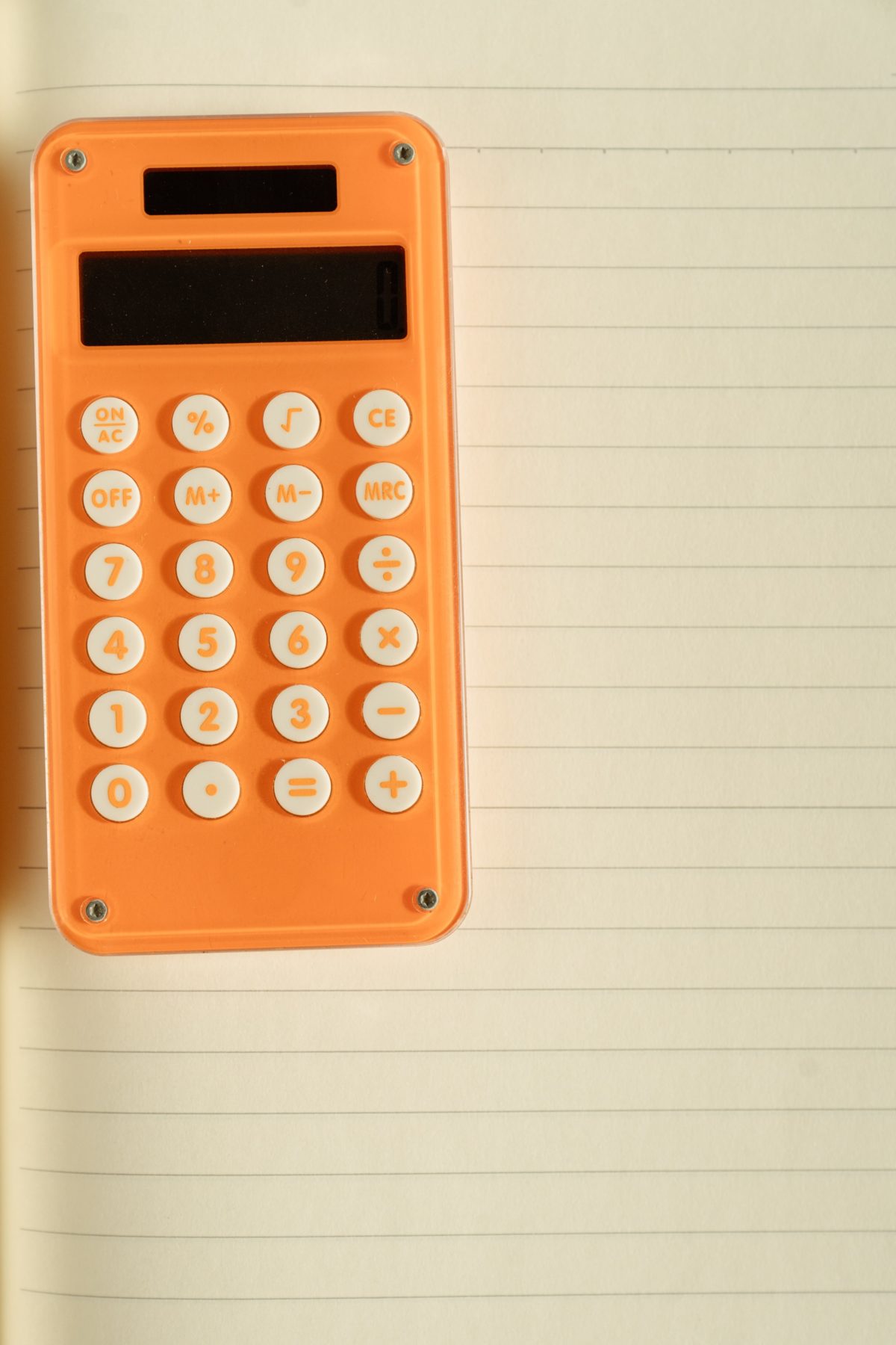 Orange calculator on a note pad.