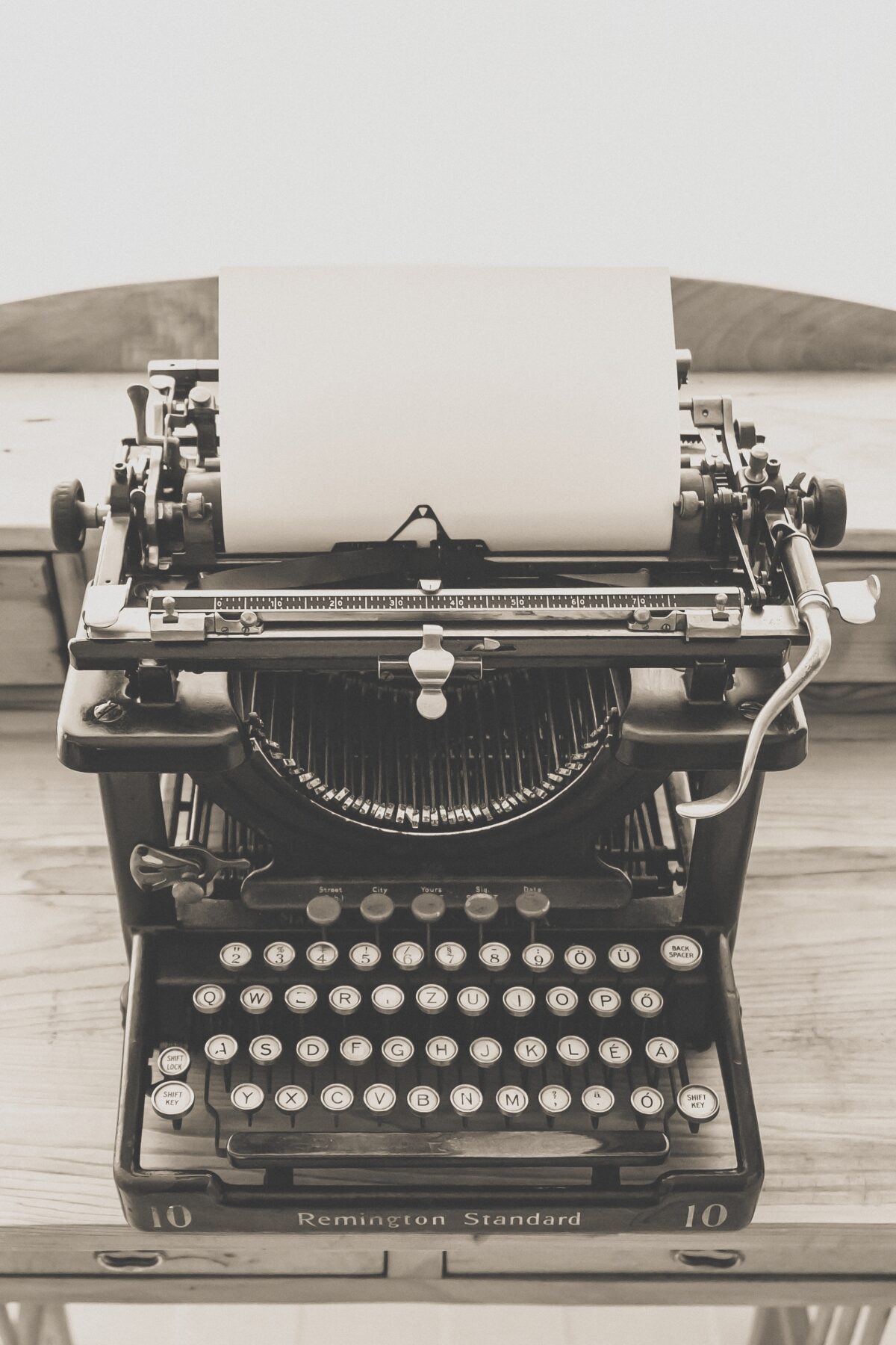 Old manual typewriter with paper loaded.