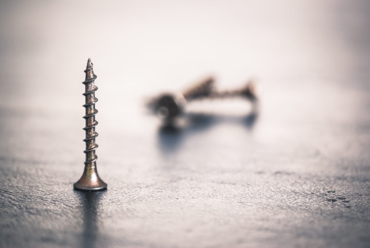 A screw standing on its head.
