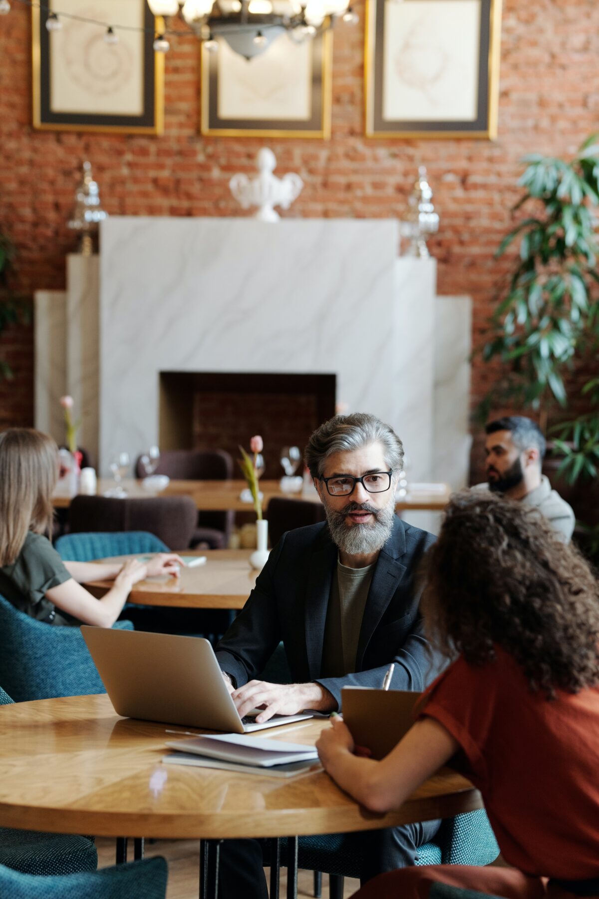 Midde-aged man sitting and speaking to young woman.