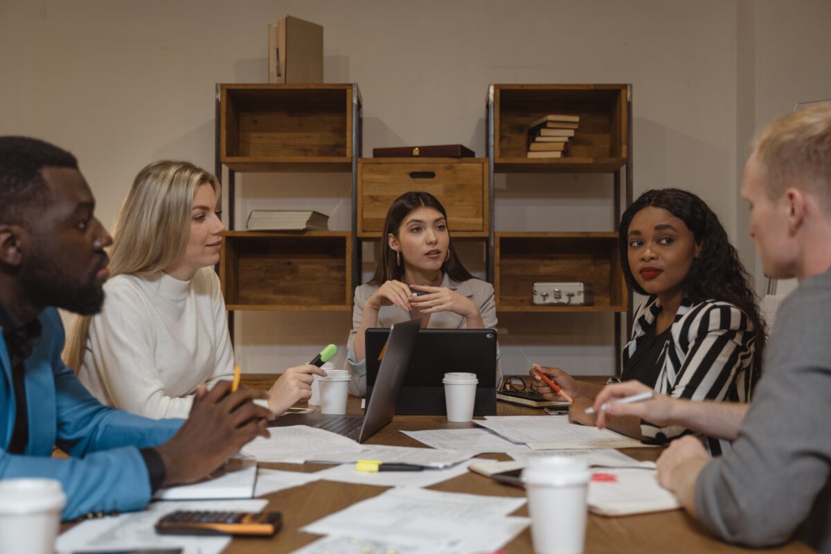 Business people attending a meeting in a boardroom.