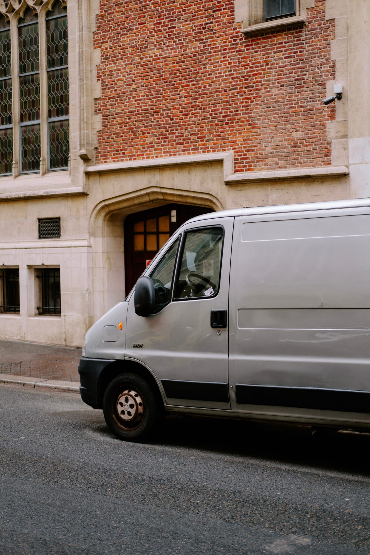 White van parked in front of a building.