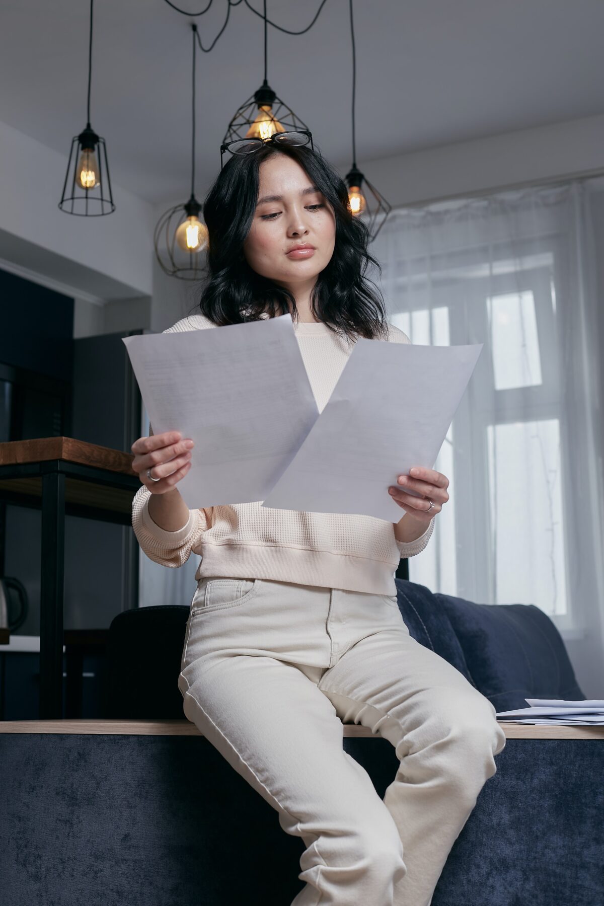 Woman looking at two pieces of paper.