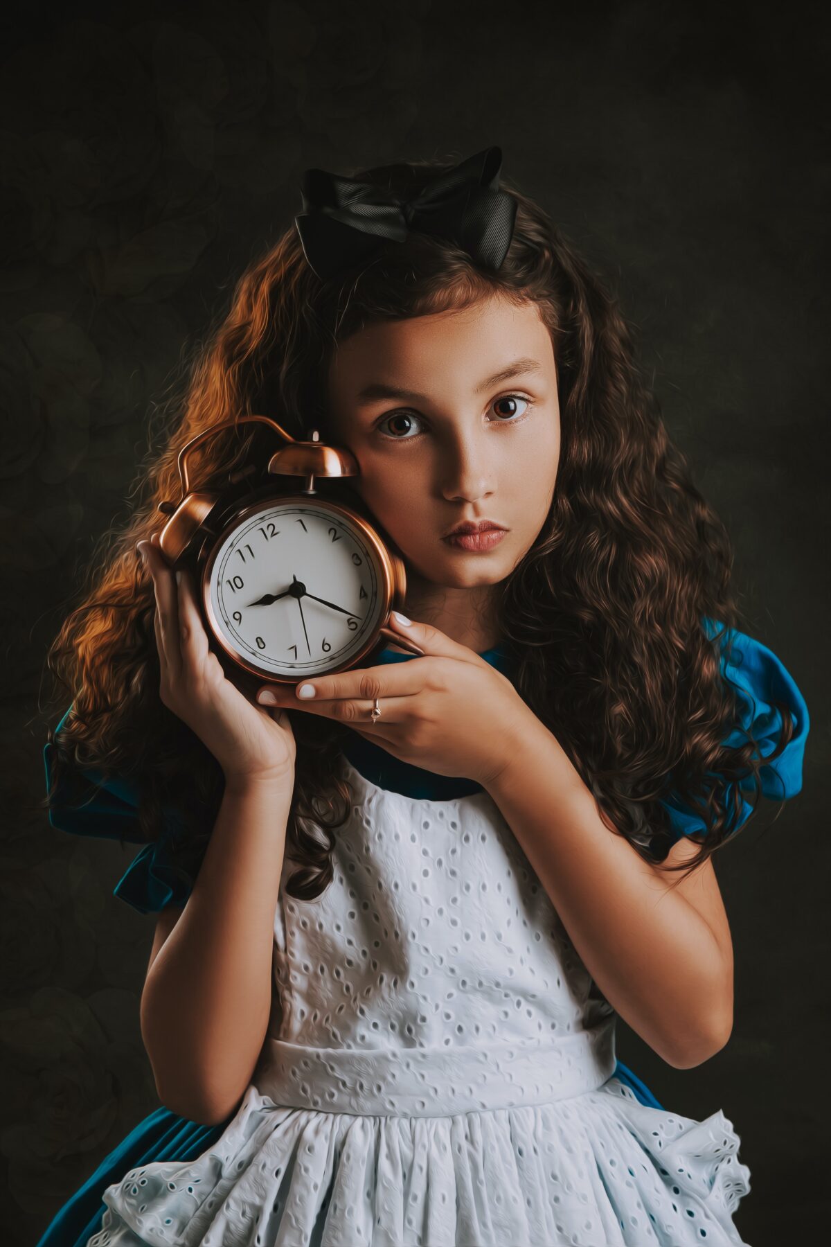 A young girl holding a clock.