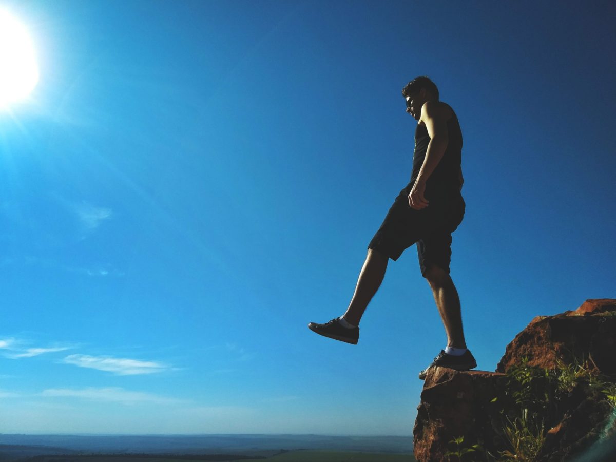 Man stepping off a cliff.