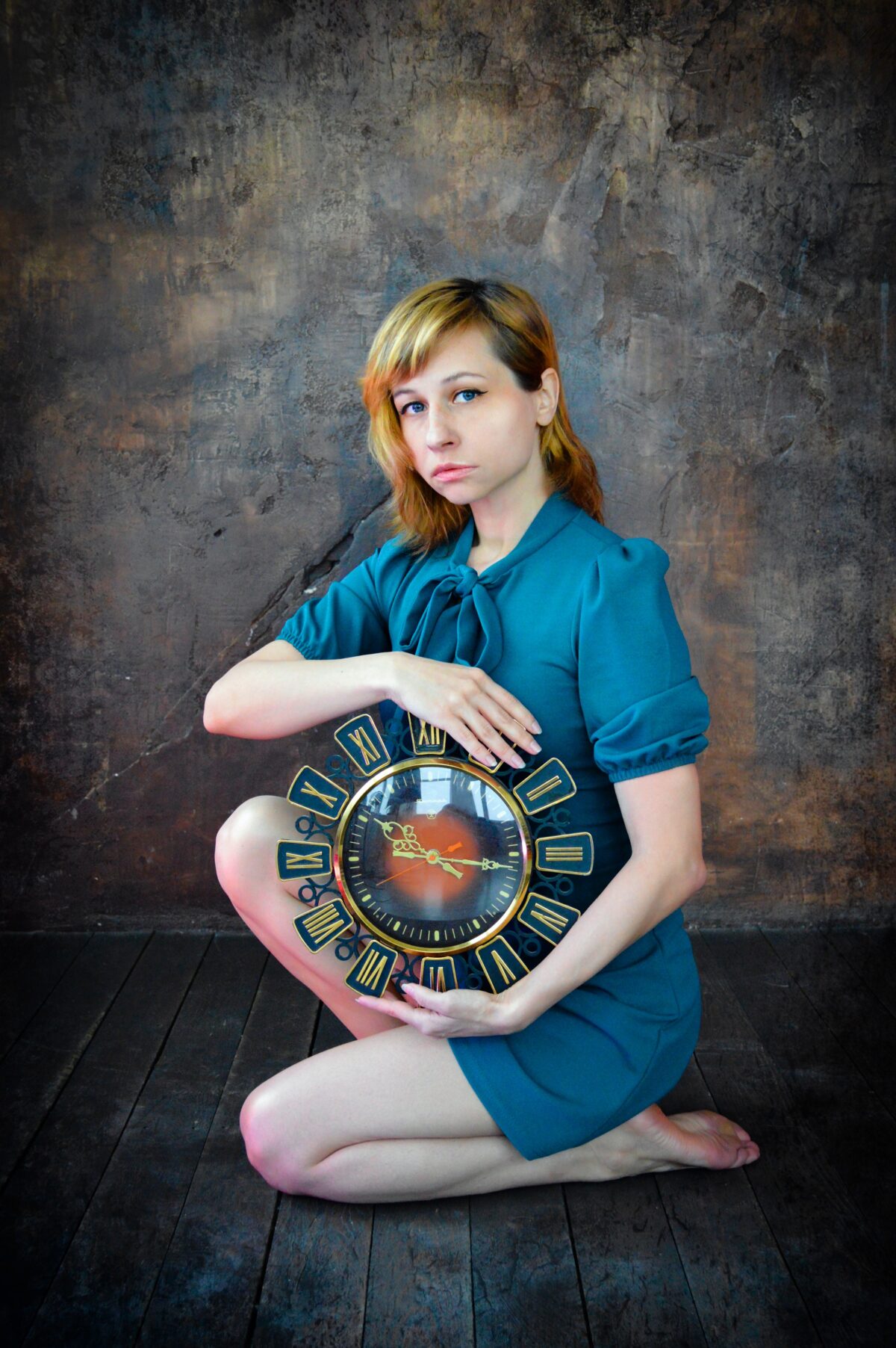 Woman holding a clock.