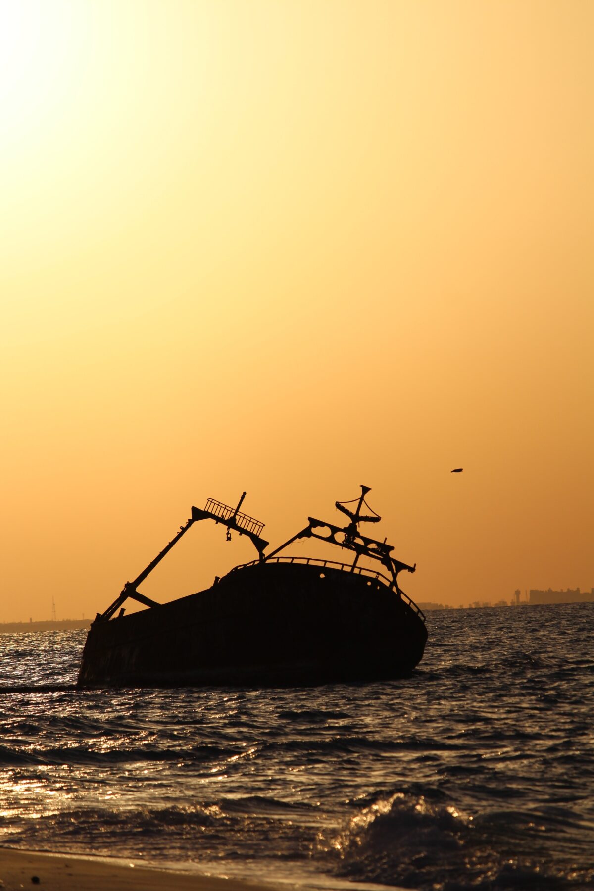 A foundering ship at sunset.