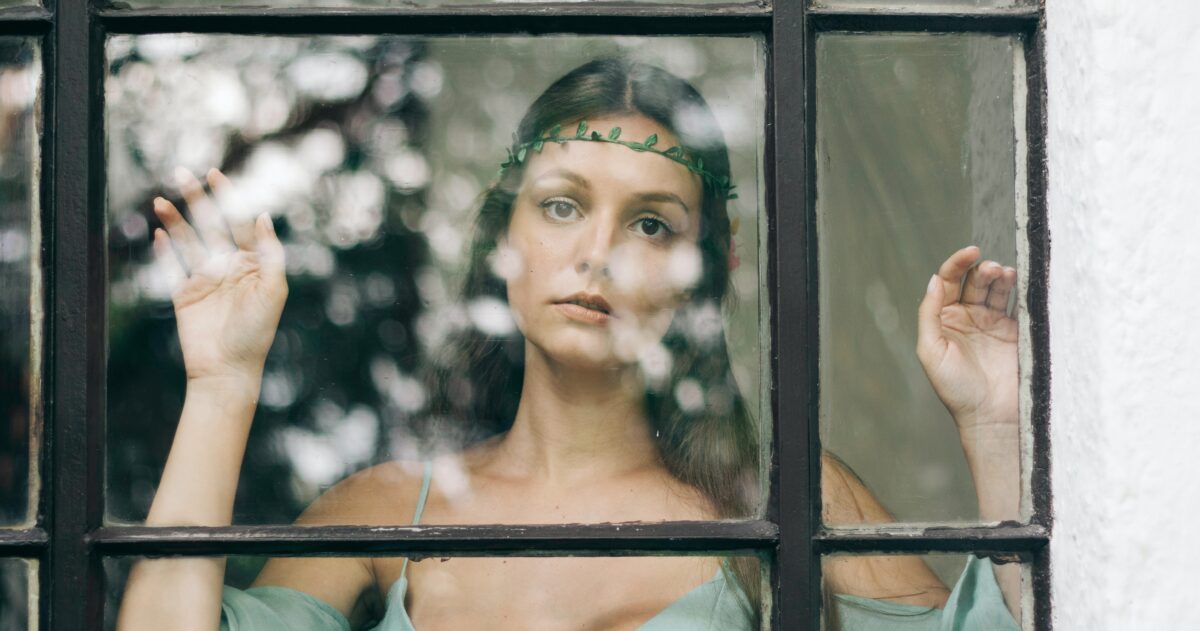 Woman staring into window.