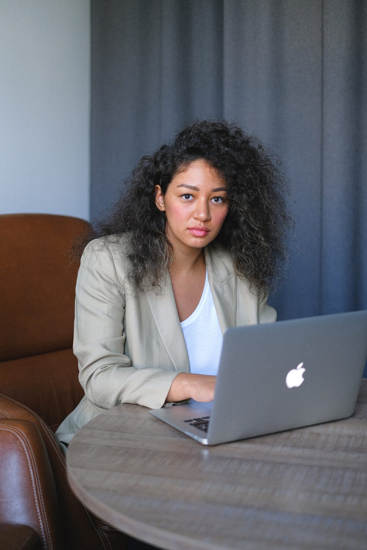 Professional looking woman working on a laptop.