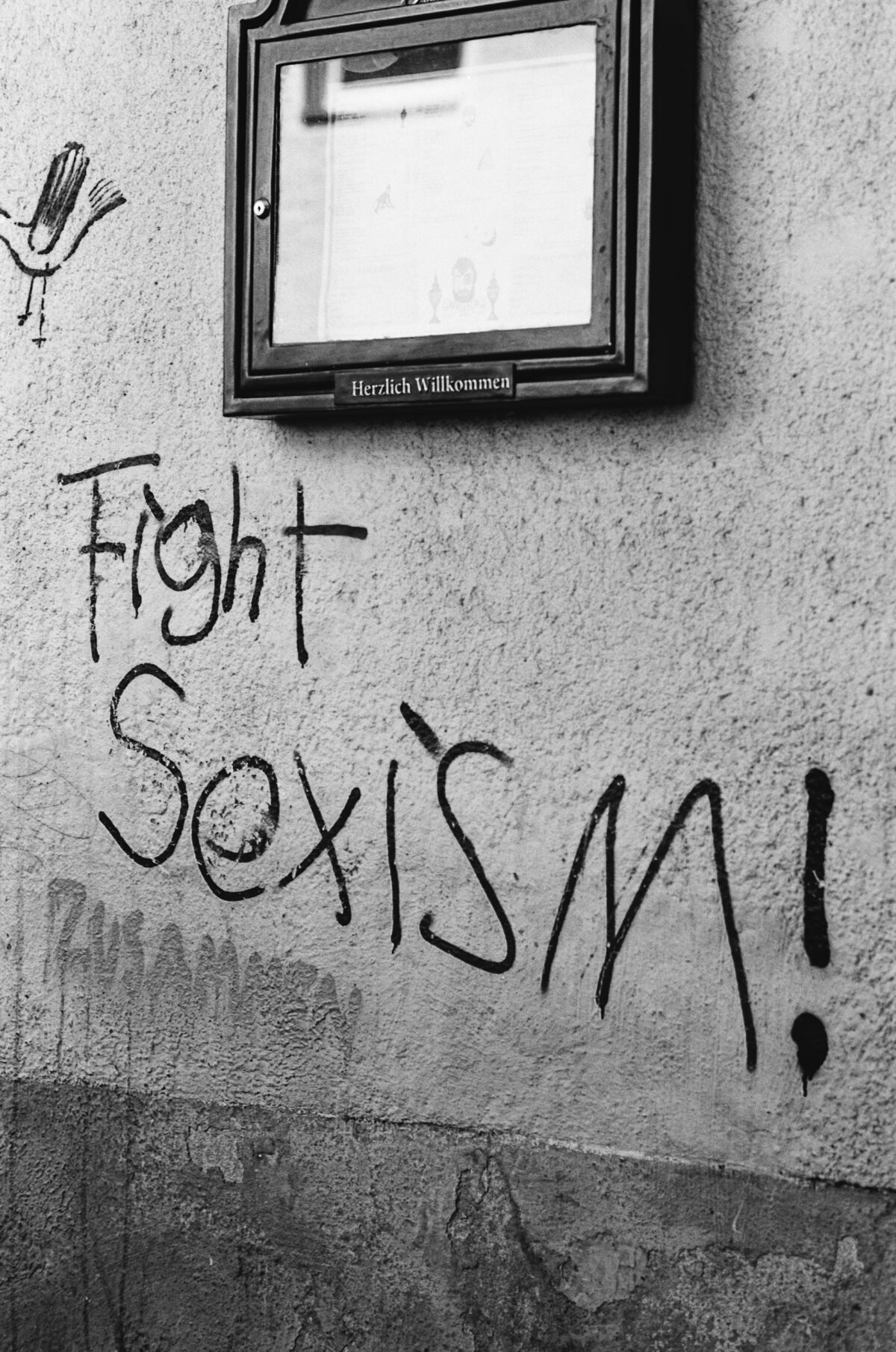 Sign on wall that says "Fight Sexism."