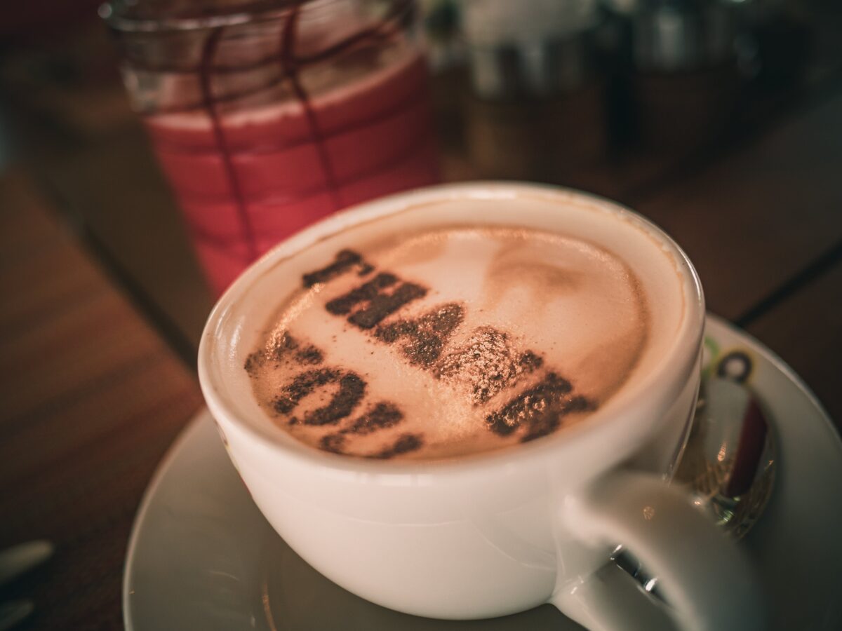 Cup of Coffee with "Thank You" spelled out in the foam.