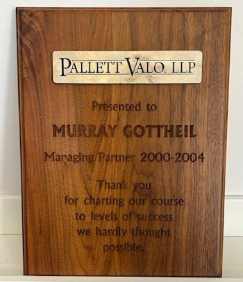 A Plaque from the Author's law firm which thanks him for setting the firm's path to levels of success that they hardly thought possible.