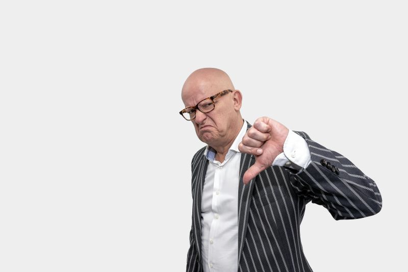 Photo by Mike van Schoonderwalt at Pexels. man flashing the thumbs down sign.