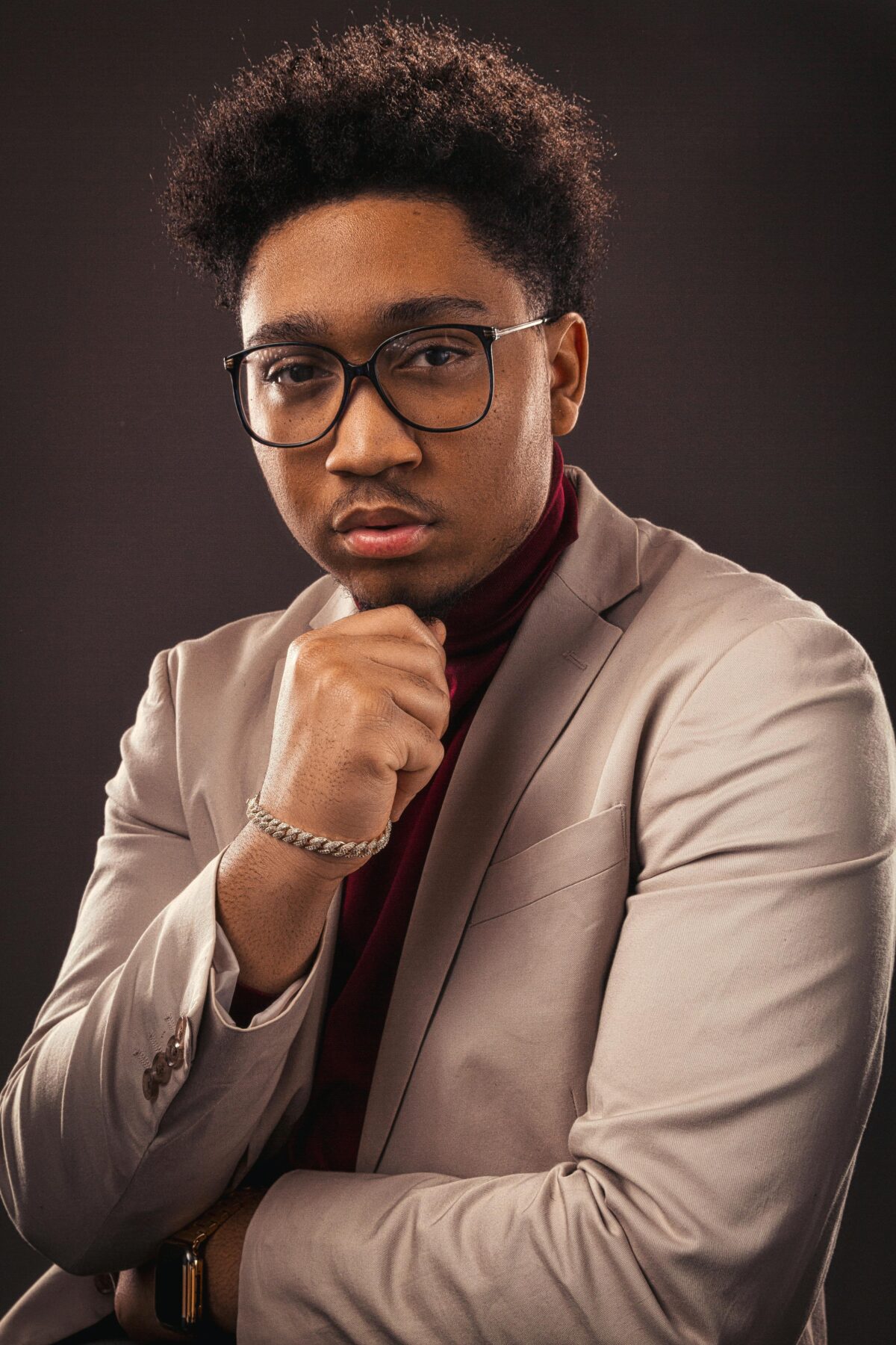 Man with glasses in a formal pose.