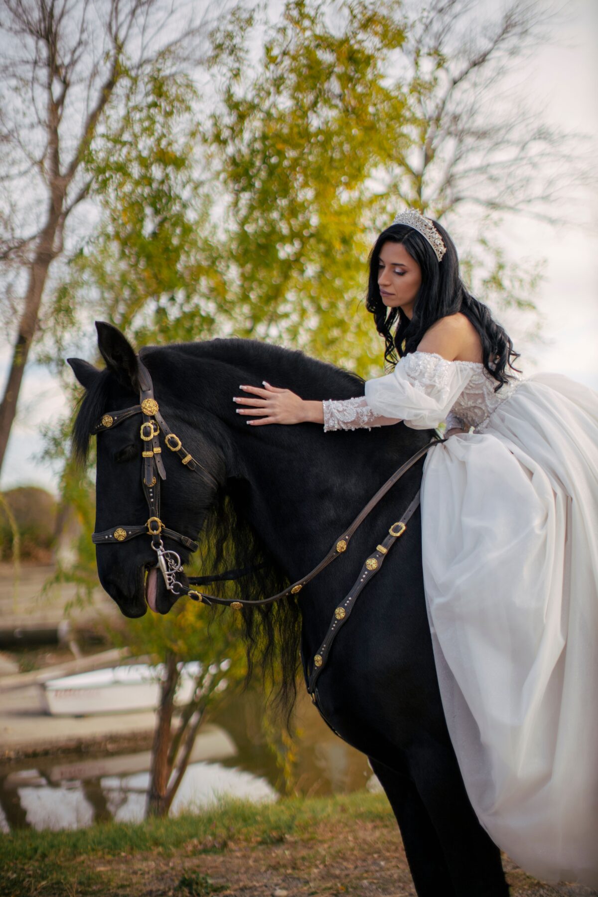 A bride wearing a tiara, on a horse.