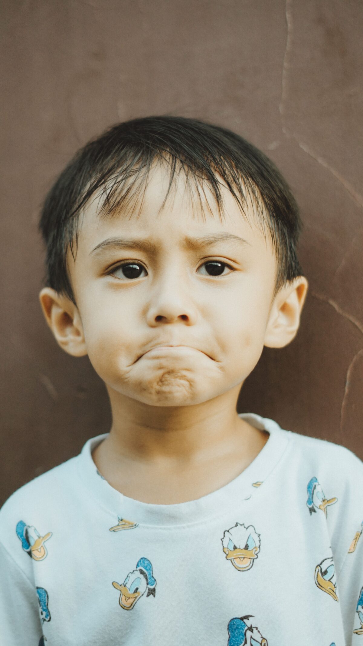 A small boy's face, looking petulant.